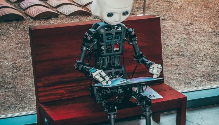 black and white robot toy on red wooden table